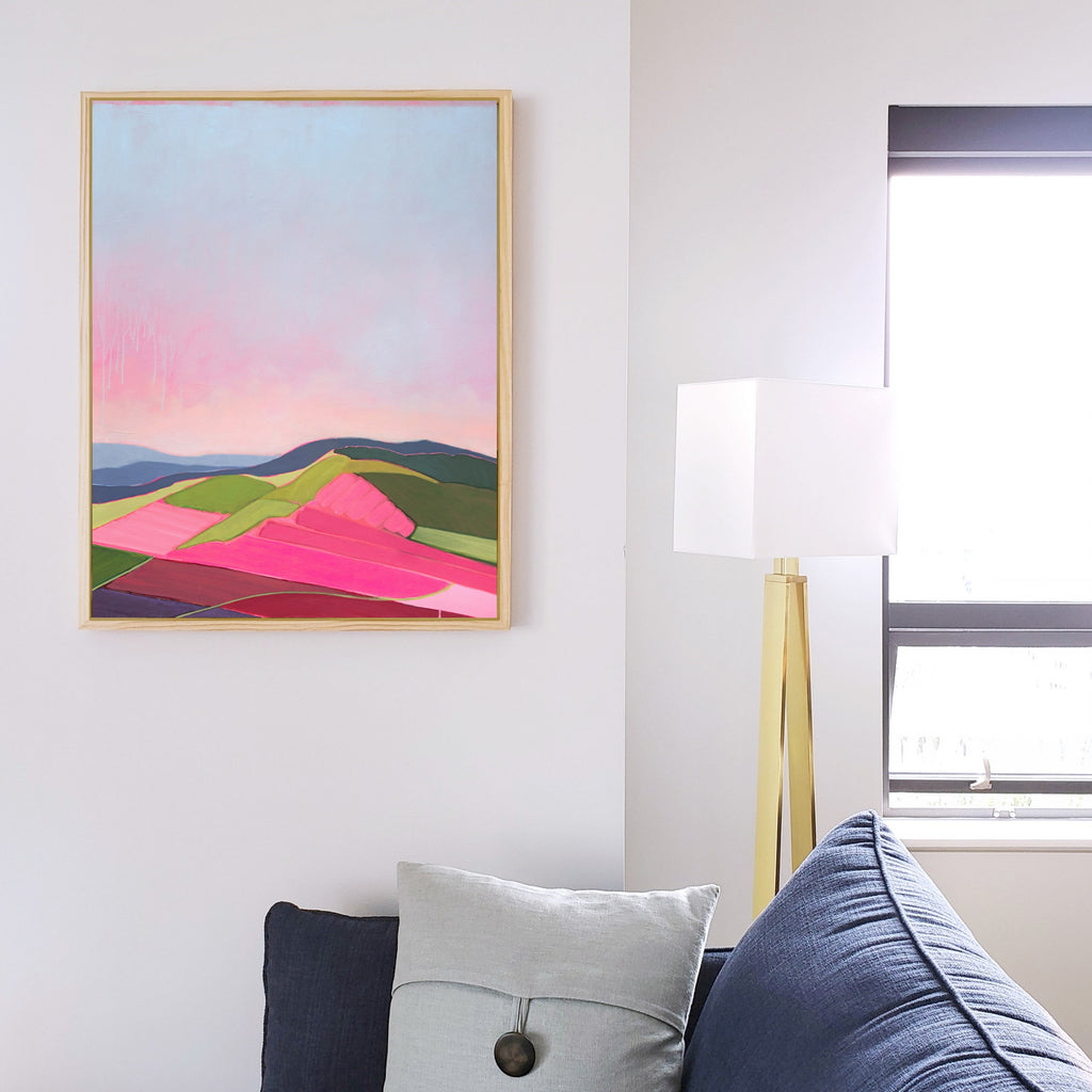 Abstract pink landscape art in living room