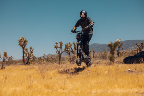 a man riding kaabo-wolf-warrior-11-scooter-offroad-riding