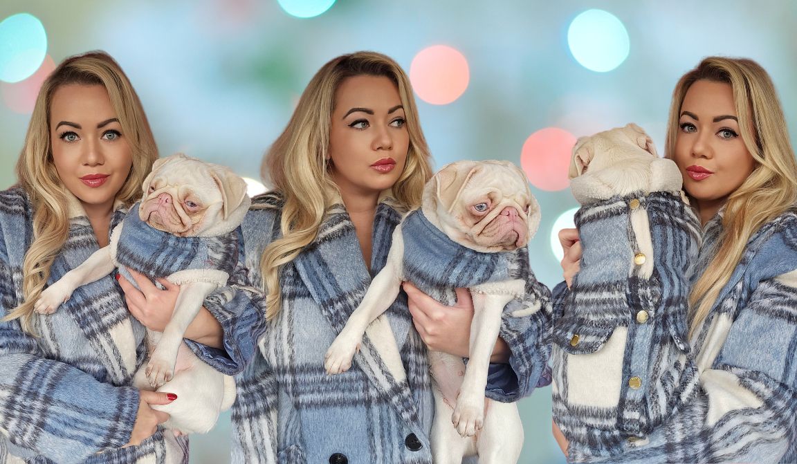 Pug Mom who is wearing a blue plaid coat, holding a pink pug wearing a matching coat