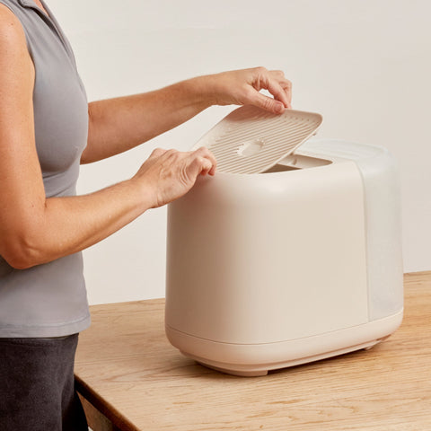 Woman lifting the grate off Canopy Large Humidifier