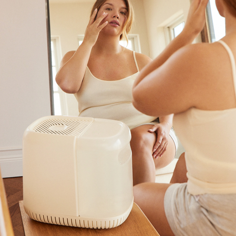 Woman in front of mirror with Canopy humidifier