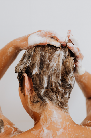 Young woman washing hair