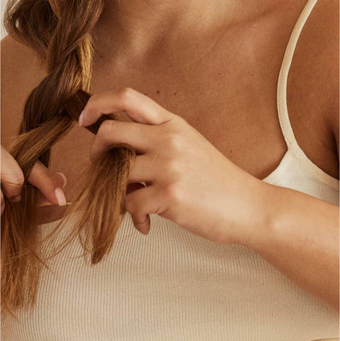 Woman braiding hair