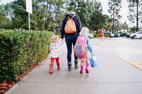 Mom walking child to school