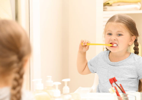 kid brushing their teeth