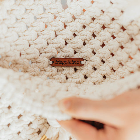 made in america handbag, showing the small tag inside of the bag that reads "Fringe & Free"