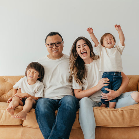 a husband, wife, and two sons wearing the organic everyday tee