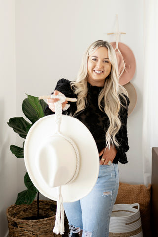 Photographer Brittany Bunker holding the Boho Hat Holder