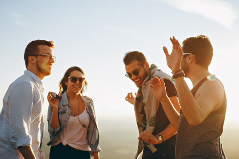 A group of friends laughing in the sunshine