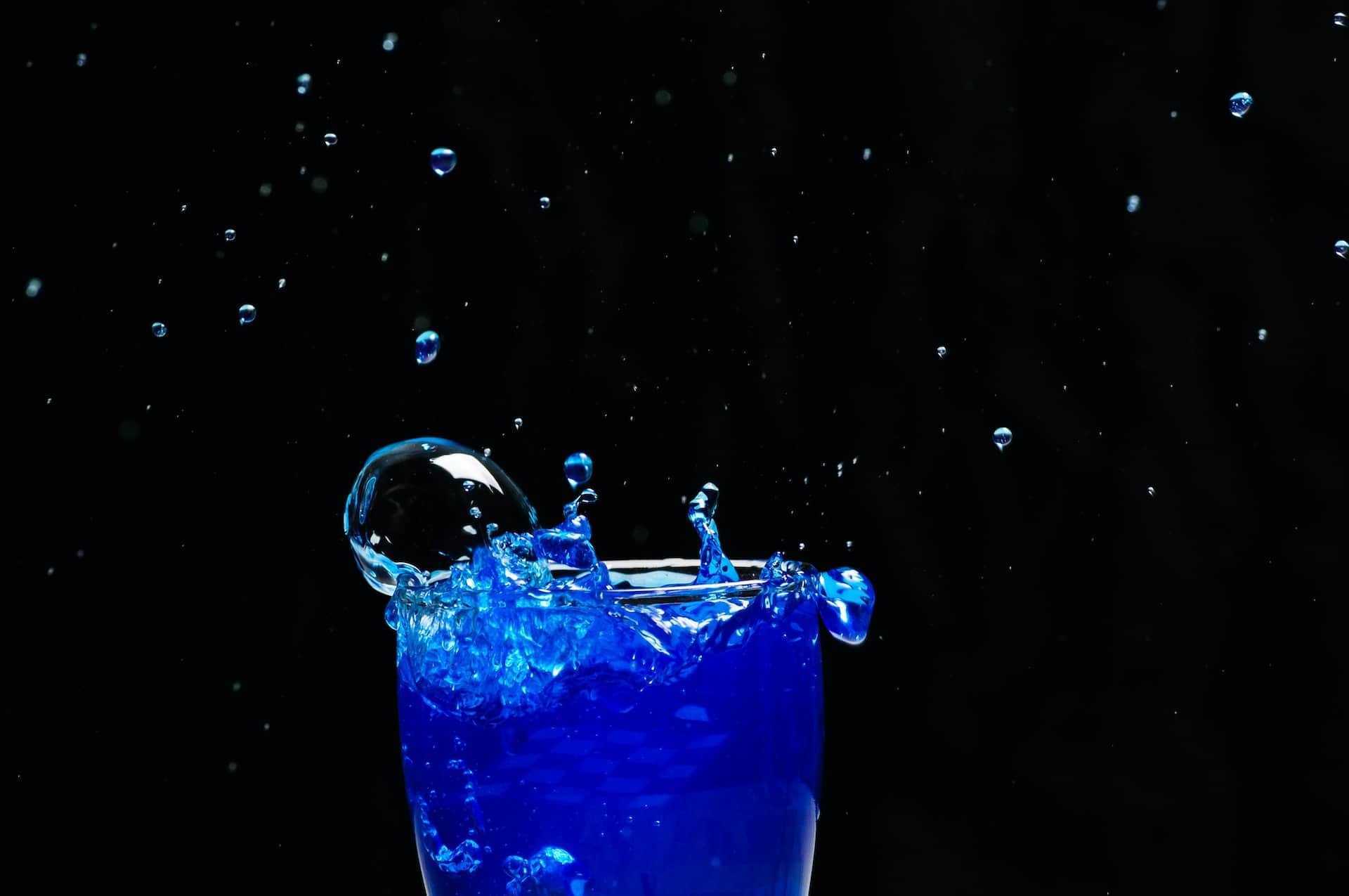 A glass of a blue drink