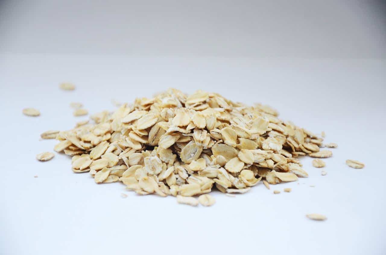  pile of whole grain oats on a white table