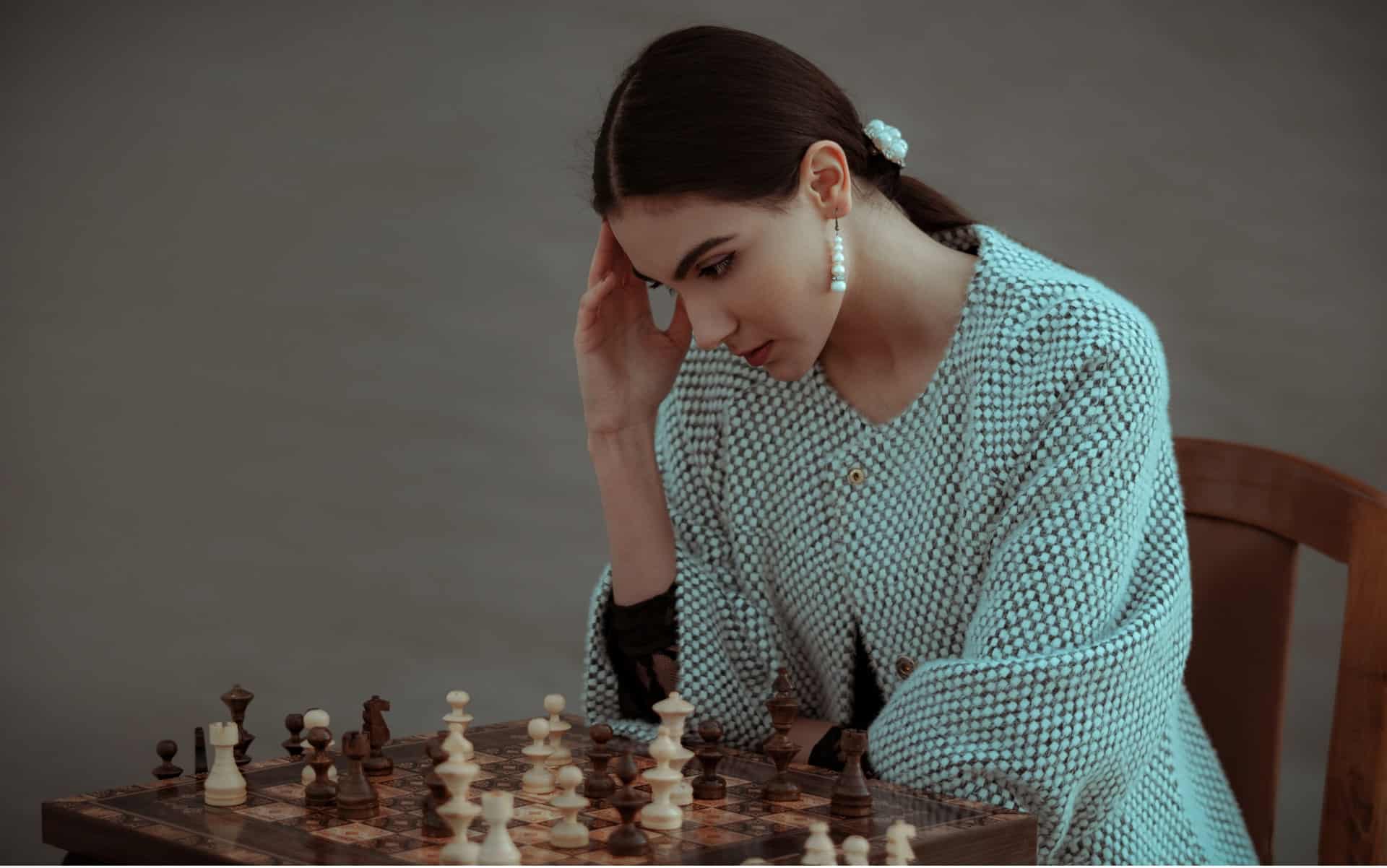 Woman learning to play chess