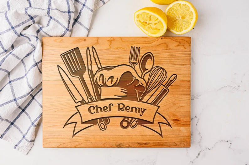 engraved cutting board with kitchen utensils