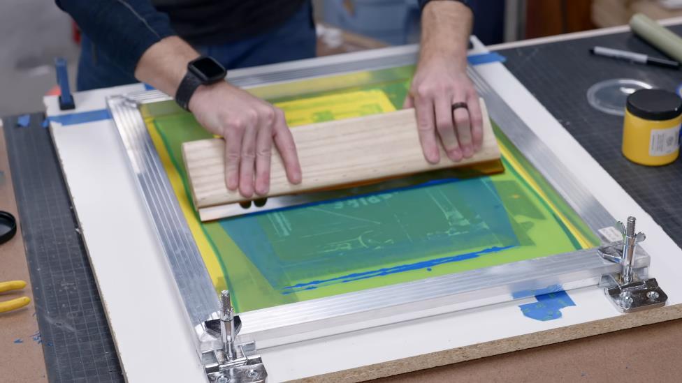 spread ink with the squeegee