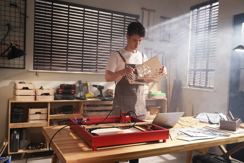 a man making wooden craft using xTool D1 pro laser cutter