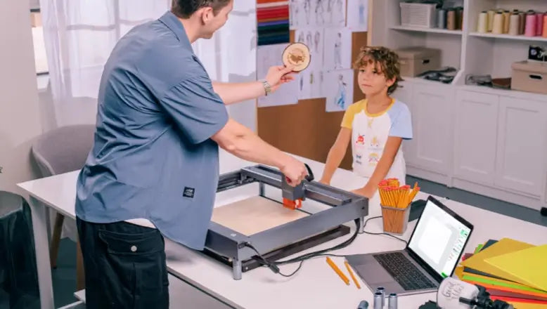 students using laser cutter