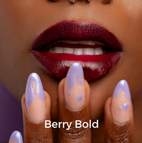 Model applying purple lip stain | Standard Beauty