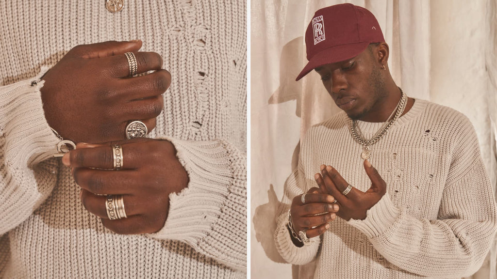 Man wearing red hat, white jumper and Silver Cuban Link Chain with matching rings