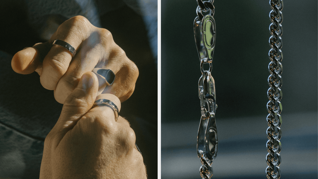 Up close image of man earring multiple sterling silver rings and a cuban link chain