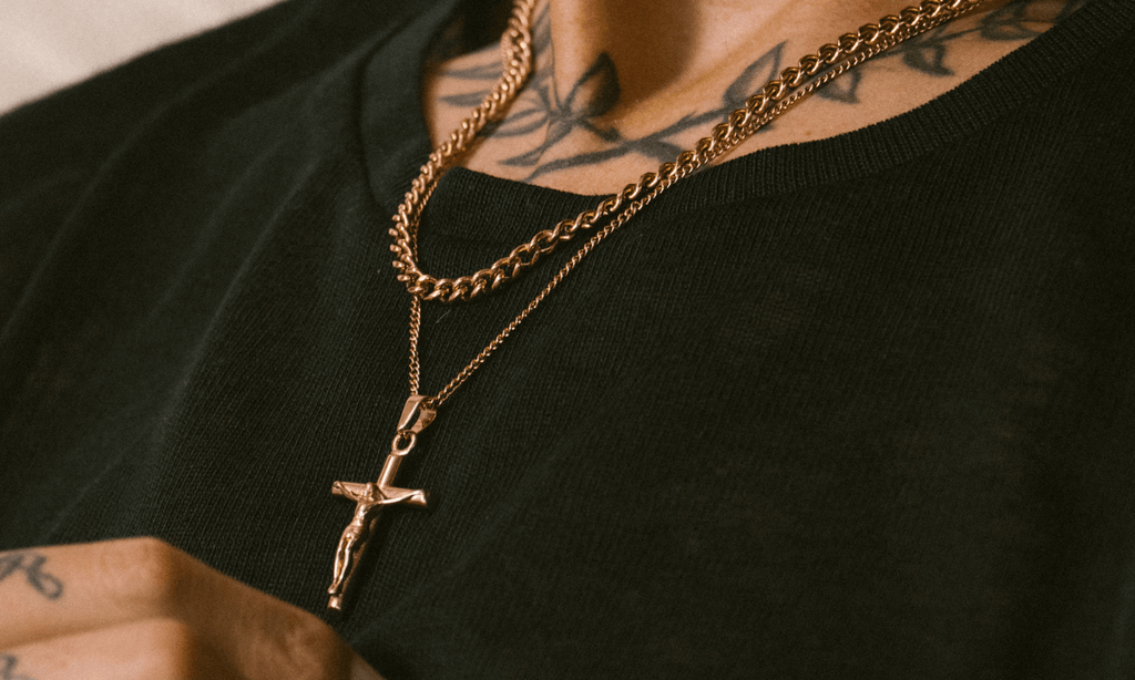 Man wearing a thin black wool jumper and layering a 4mm Cuban Link Chain in Rose Gold