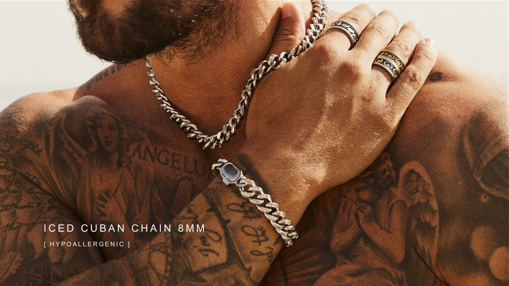 Man with tattoos wearing a silver Cuban Link Chain
