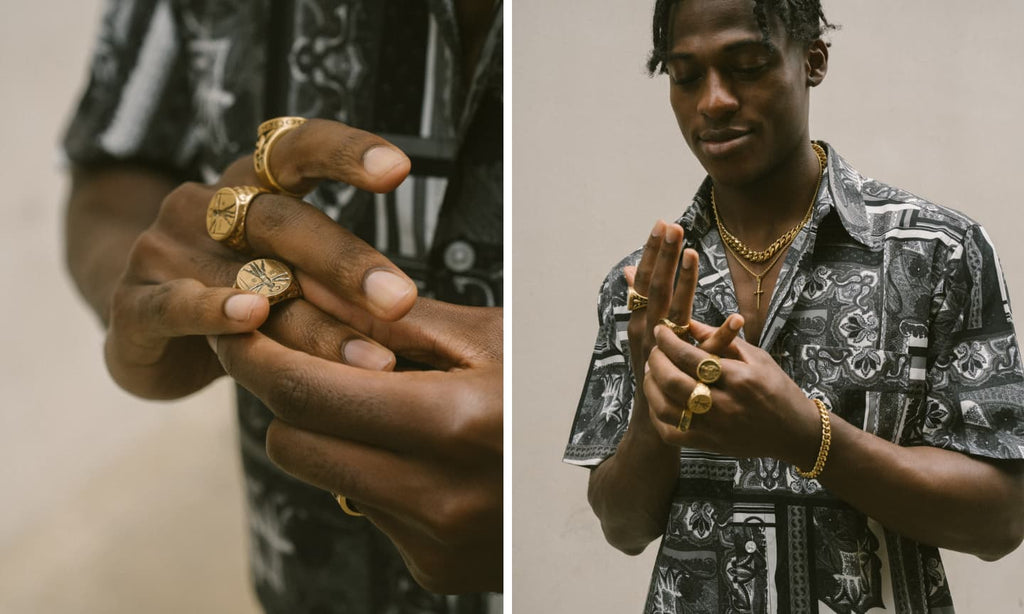 Man's hands wearing a Gold Cuban Link Bracelet and other gold signet rings and jewellery