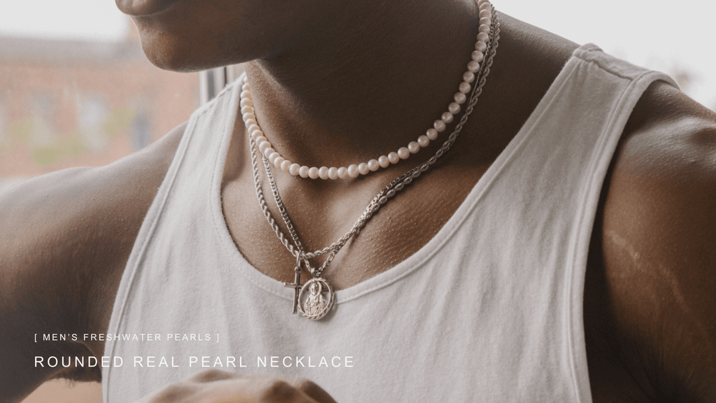 Man in a plain white casual vest wearing silver jewellery and real rounded freshwater pearls for men