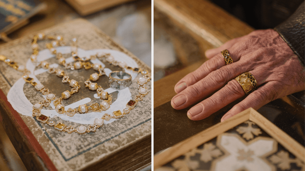 Man's hand on a desk wearing a men's 18K Gold signet ring