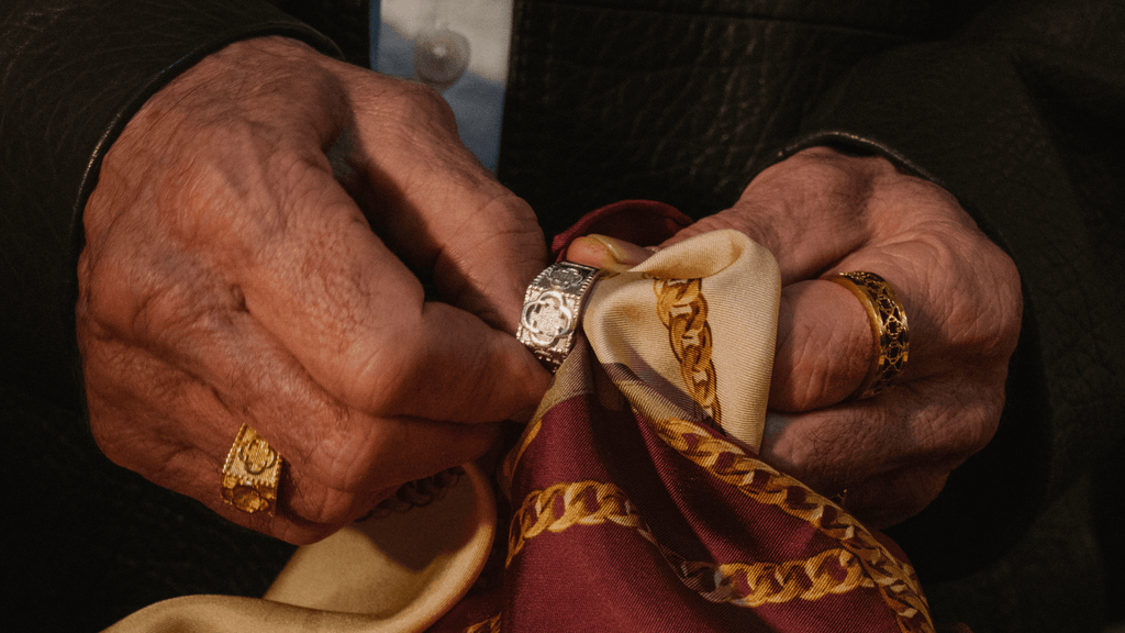 Man polishing a sterling silver ring with a red jewellery cloth