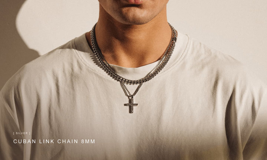 Man wearing a basic white t-shirt and styling a Silver Cuban Link Chain and other men's jewellery