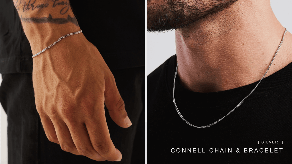 Man wearing a plain black t-shirt and styling a sleek silver Connell chain and bracelet set