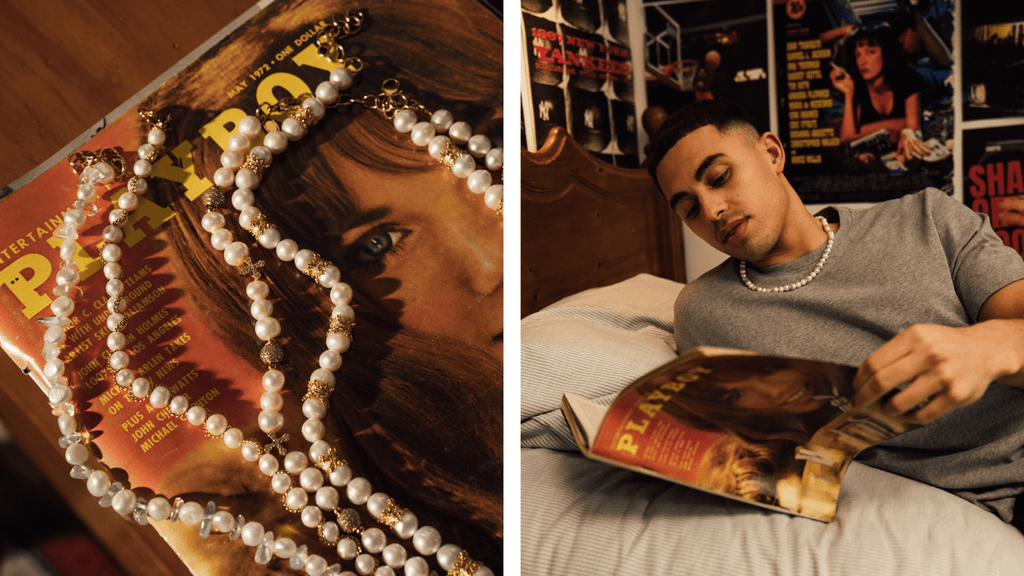 Man reading a playboy magazine with men's pearl necklaces spread across his bed