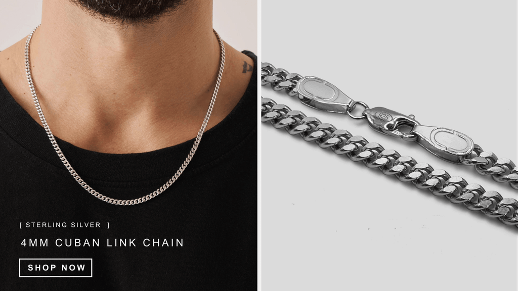 Man wearing a plain black t-shirt and layering a classic sterling silver cuban link chain