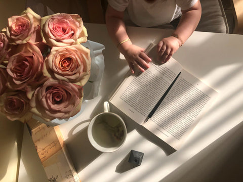 Roses, Coffee, and a Journal at a Table