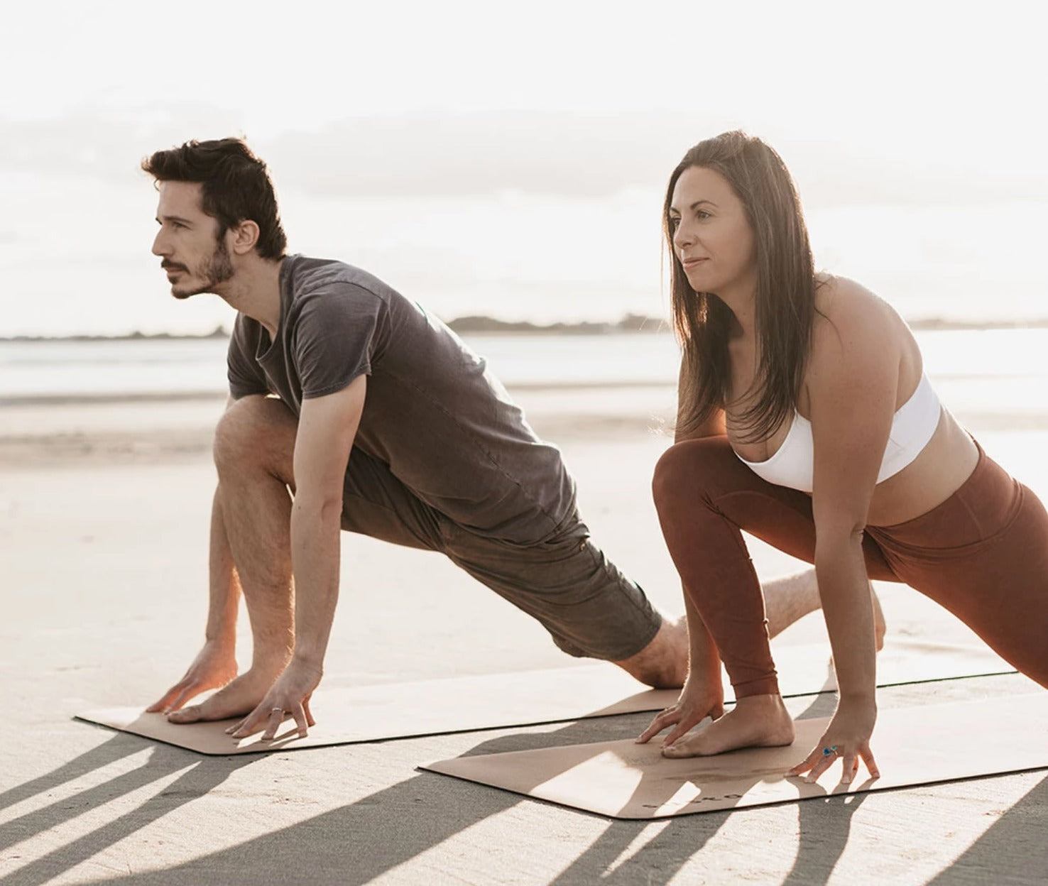 A couple practicing yoga on cork yoga mats. 