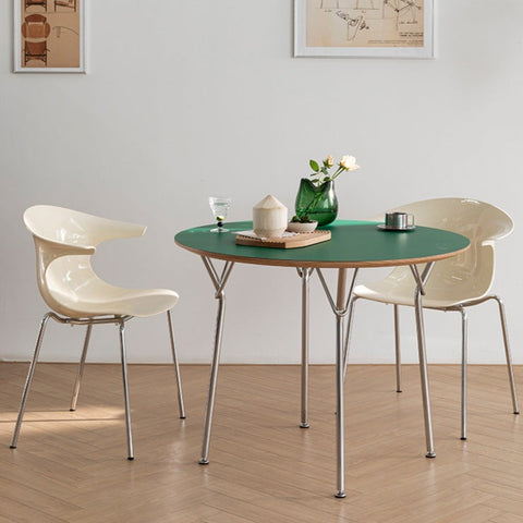 green table and white chairs