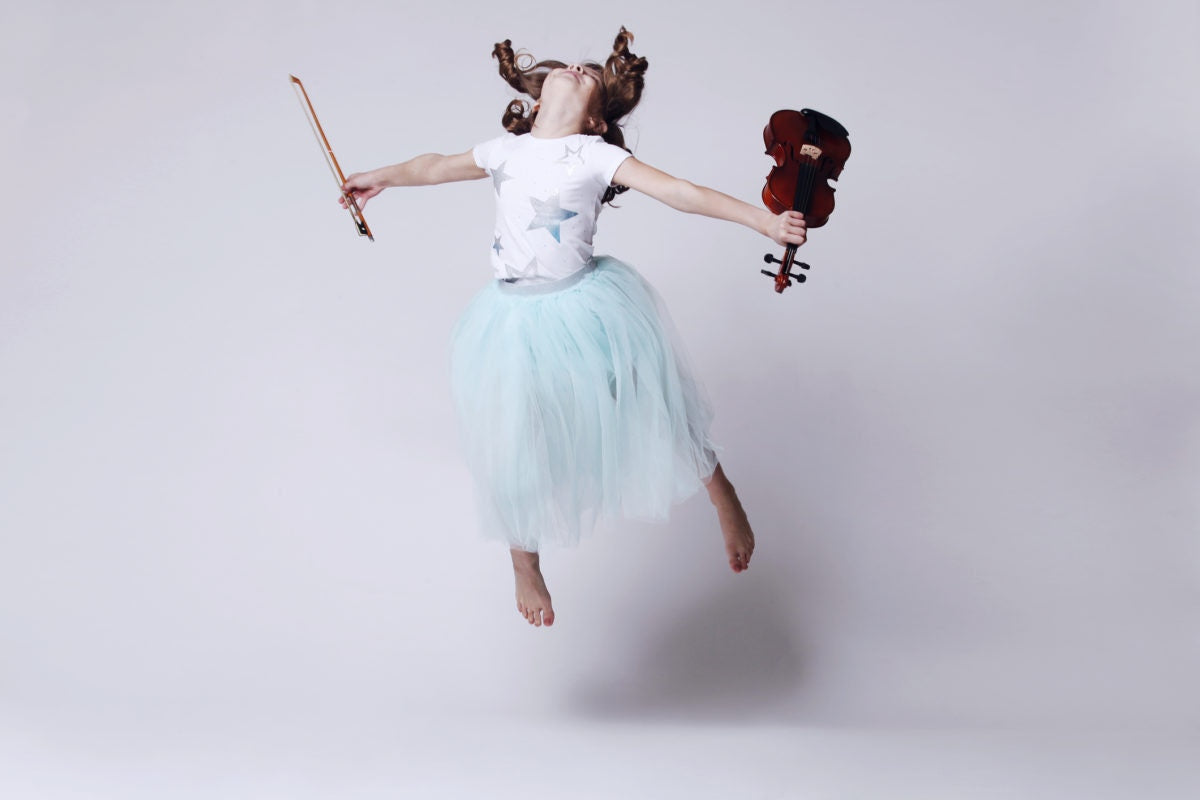 Girl playing violin and jumping