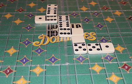 shot of the dominoes fitting on the board.