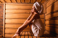 Woman with towel in sauna