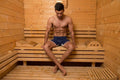 Young guy in sauna with clothes