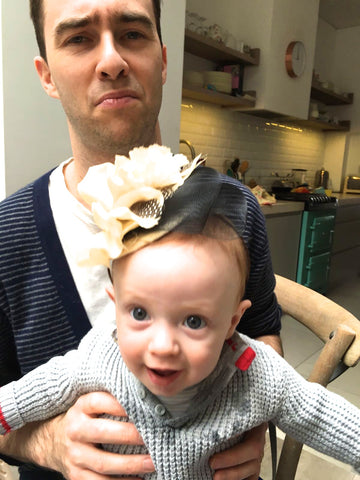 Step-brothers baby wearing his mum's fascinator