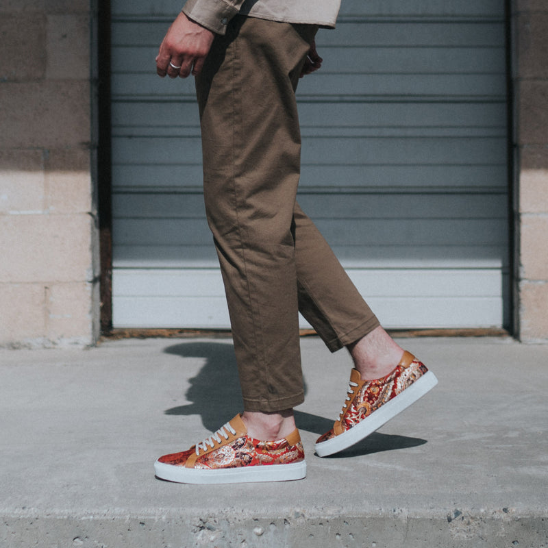 model walking in sneaker in red paisley