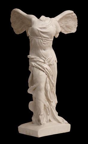photo of plaster cast sculpture of headless female figure with wings and drapery