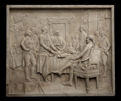 Photo of plaster cast sculpture relief of the signing of the American Declaration of Independence depicting John Hancock, Thomas Jefferson, John Adams, and Benjamin Franklin