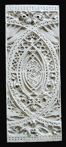 Photo of white plaster cast of architectural ornamentation detail