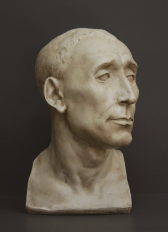 photo of plaster cast sculpture bust of man, namely Niccolo da Uzzano, in Antique Plaster Patina on a dark gray background