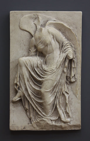 photo of cast of sculpture relief of robed figure, head now missing, reaching for her sandal in Antique Plaster Patina on a dark gray background