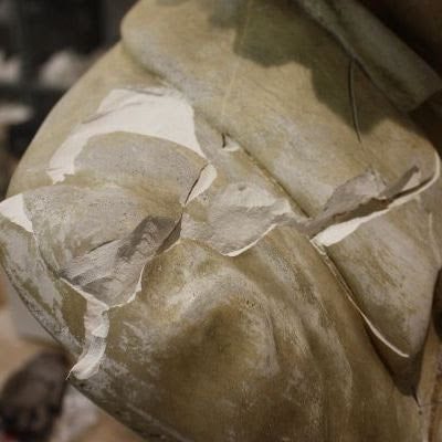 closeup photo of shoulder of yellowed, damaged plaster cast sculpture bust of Hagen's Beethoven