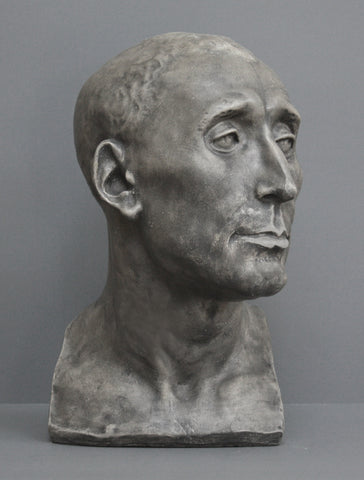 photo of plaster cast sculpture bust of man, namely Niccolo da Uzzano, in Dark Stone Patina on a gray background