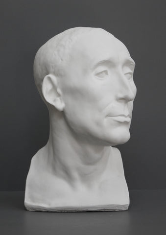 photo of plaster cast sculpture bust of man, namely Niccolo da Uzzano, in Flat White Patina on a dark gray background